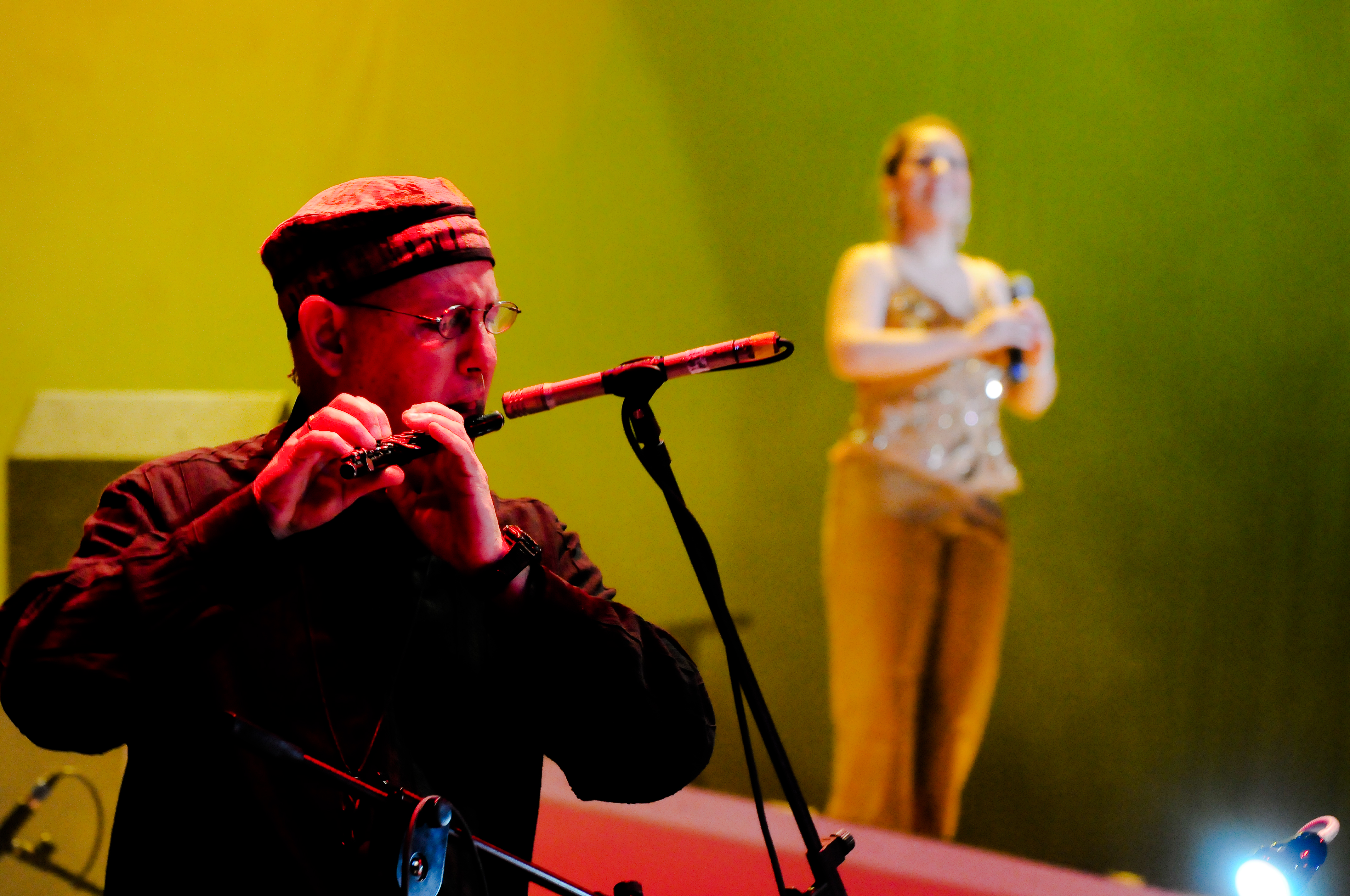 Flutist performing with Patricia Vlieg in the background